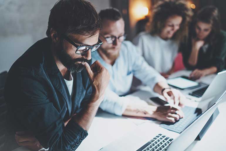 Credgroup of people working at their laptops